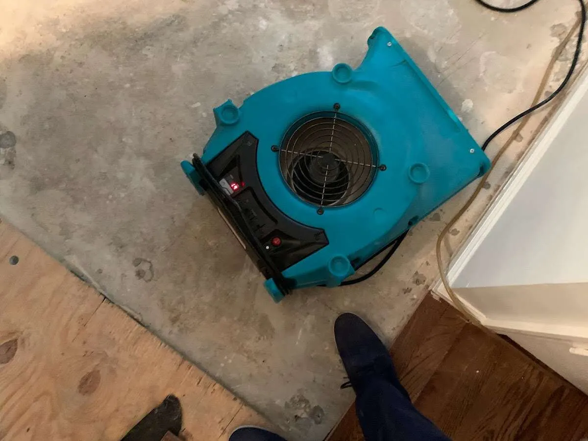 Air mover drying subfloor during Commercial Water Damage Restoration in Franklin Farm